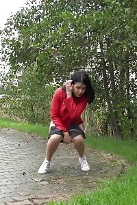 Black Haired Striking Babe Squatting To Piss Outside